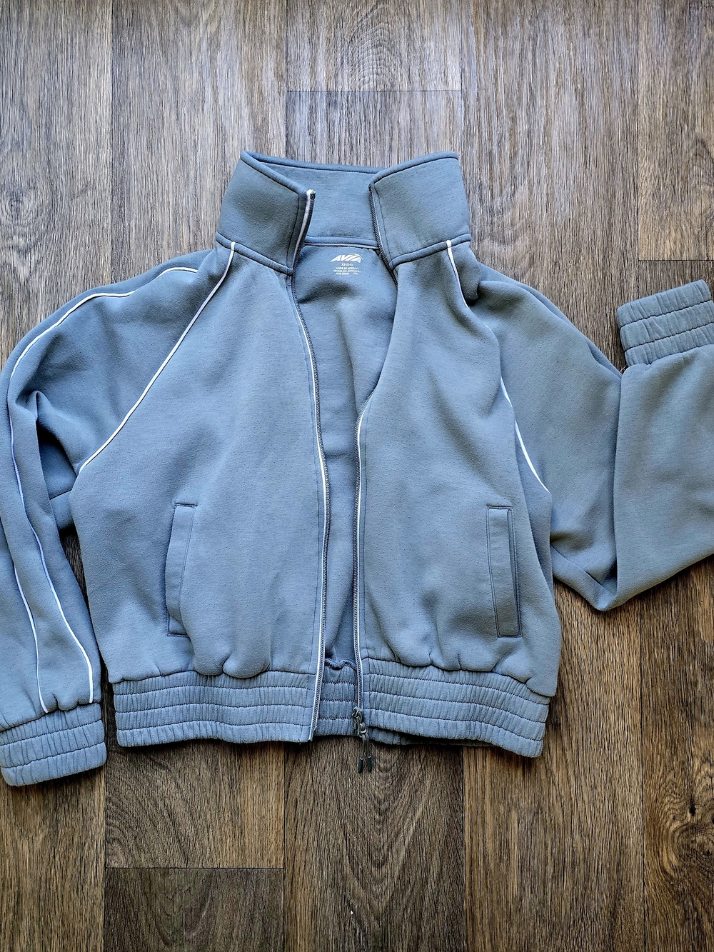 Avia women’s full-zip athletic track jacket in a muted gray-blue color with whit